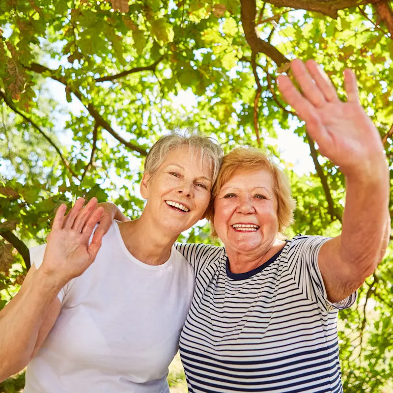 Two women waving